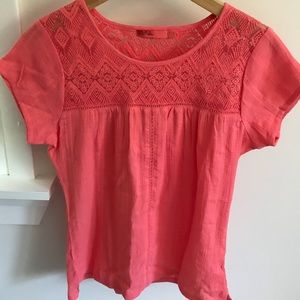 Short sleeved coral shirt.